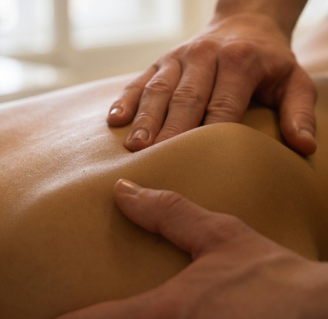 Massage therapist giving a back massage.